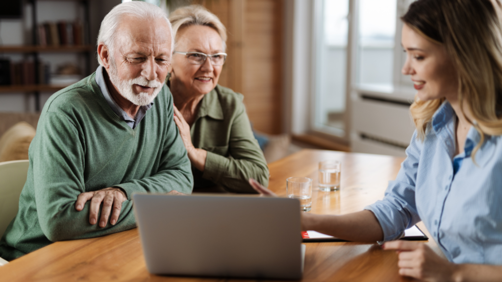 A senior couple talking with an insurance agent for Medicare