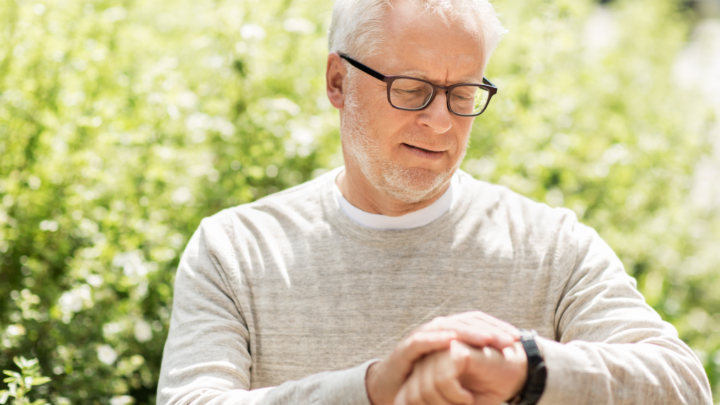 A senior man looking at his watch