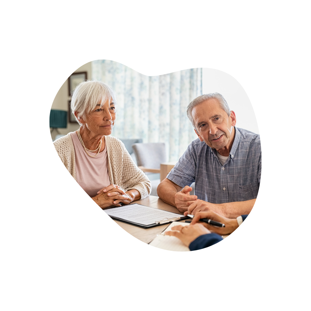 Senior couple listening intently to a Medicare insurance agent.